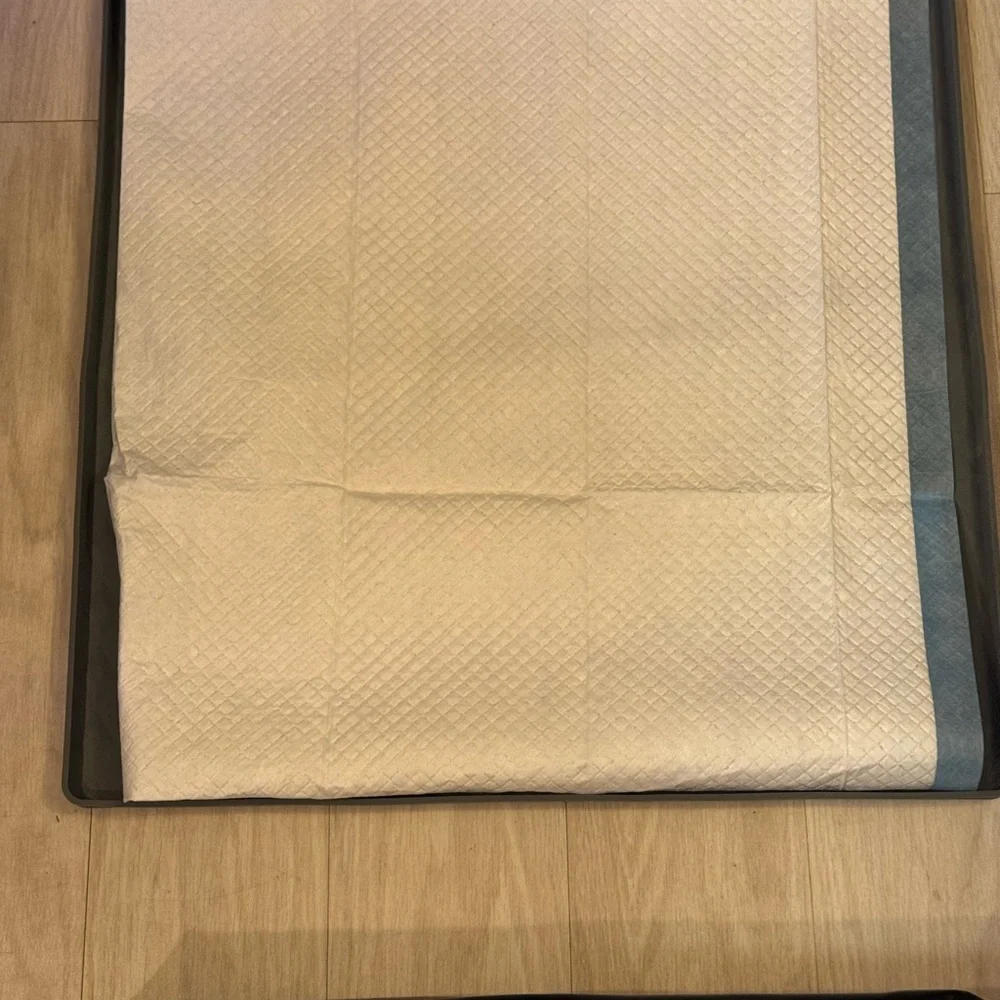 Dog potty pad holders trays bundle. One is black and one is gray.